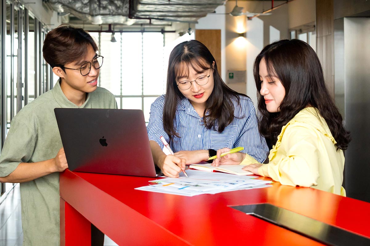 three students talking