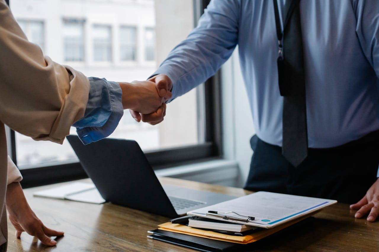 two people shake hands