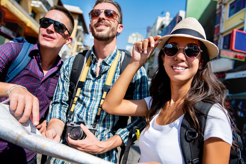 Three tourists wearing sunglasses
