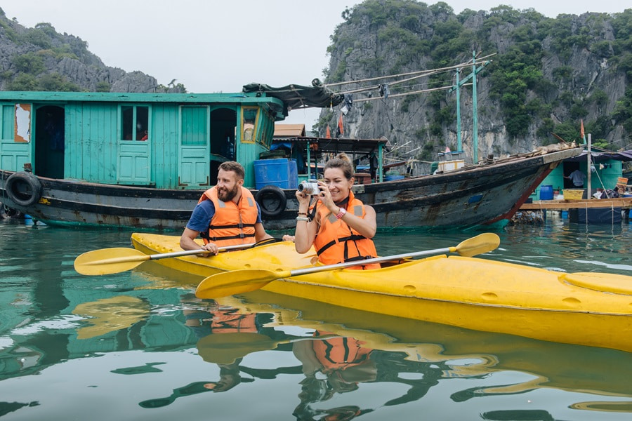 Two tourists kayaking in Halong Bay