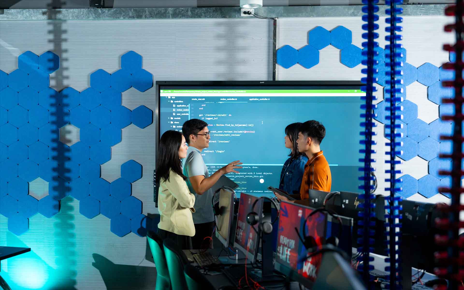 a group of post graduate students working in a computer room