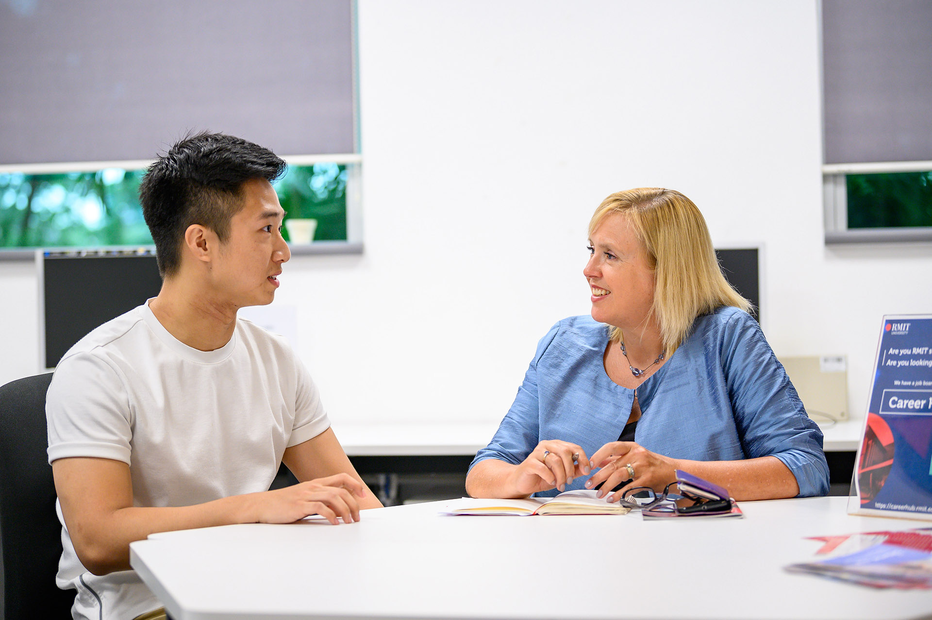 a male student and a female staff chatting