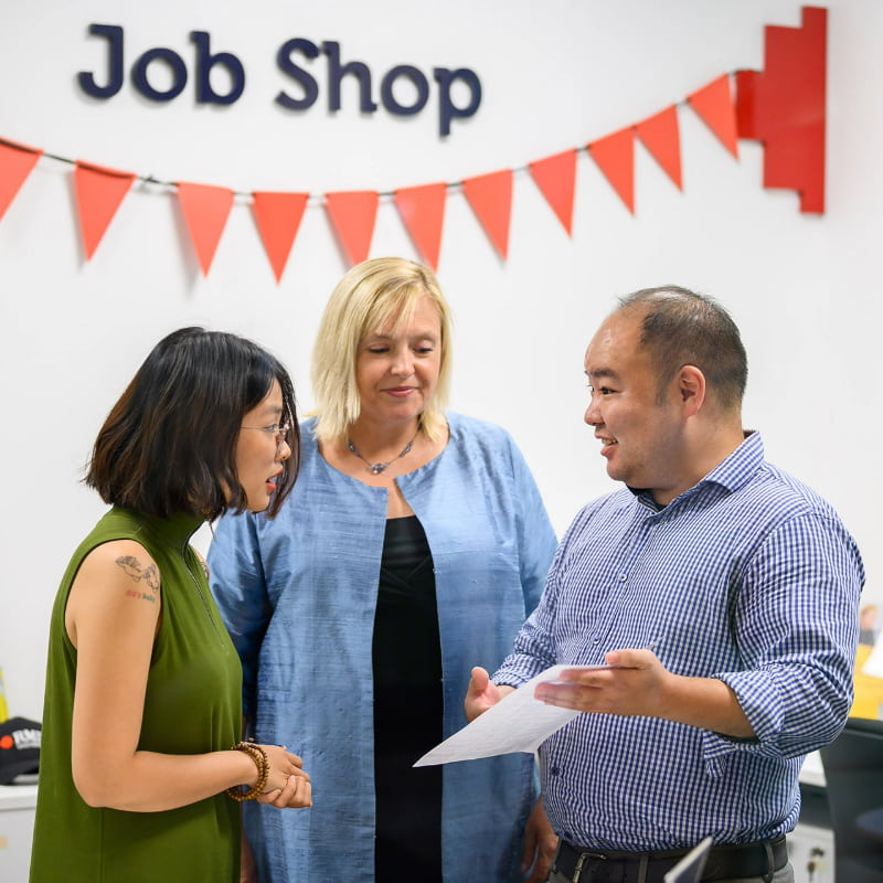 3 people speaking in RMIT Saigon South's Job Shop centre